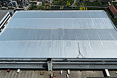 Aerial view of a large warehouse roof finished in a light membrane